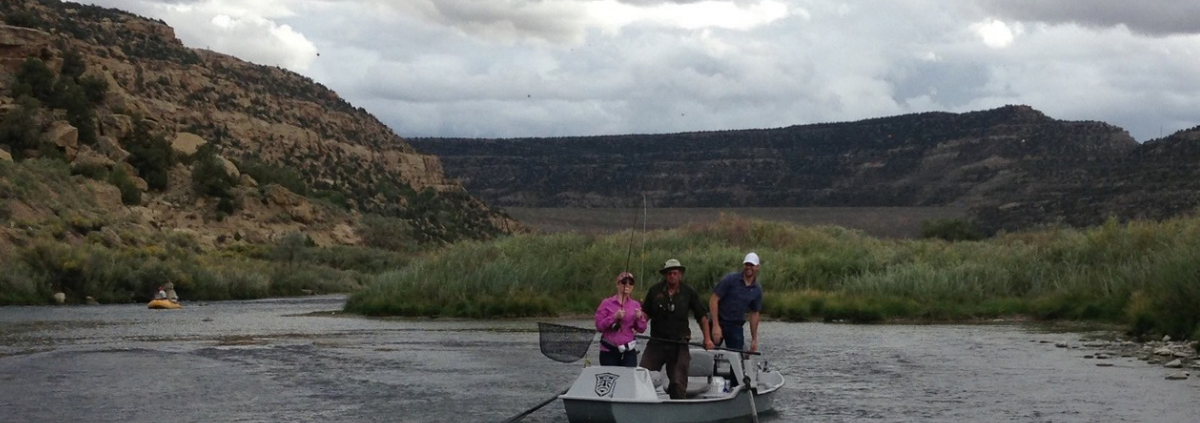 People fly fishing on the San Juan River near Quality Waters. Article about Navajo Dam NM Weather and how to dress accordingly.
