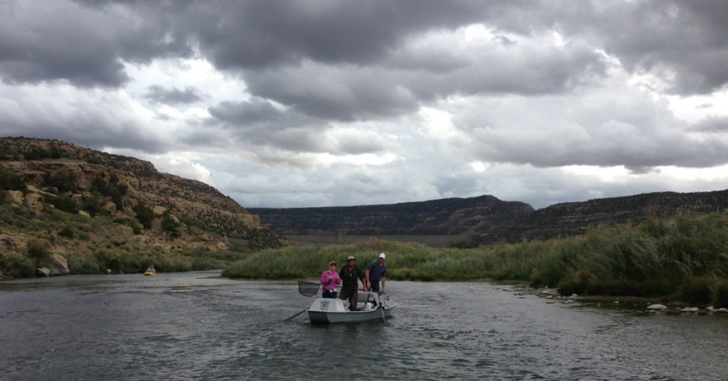 People fly fishing on the San Juan River near Quality Waters. Article about Navajo Dam NM Weather and how to dress accordingly.